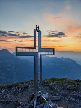 Summit cross on the fronalpstock in glarnerland above mollis glarus. Sunset hike. High quality photo.