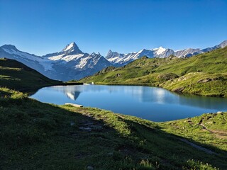 Wonderful sunrise at the Bachsee above Grindelwald. Fantastic views of the mountains and glaciers. Fiescherhorn. Lake. High quality photo