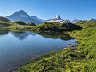 Wonderful sunrise at the Bachsee above Grindelwald. Fantastic views of the mountains and glaciers. Fiescherhorn. Lake. High quality photo