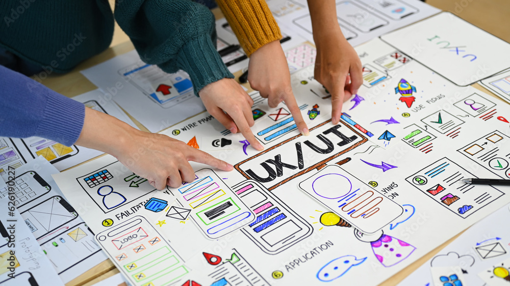 Poster cropped image of mobile application designers brainstorming, working on design project in creative o