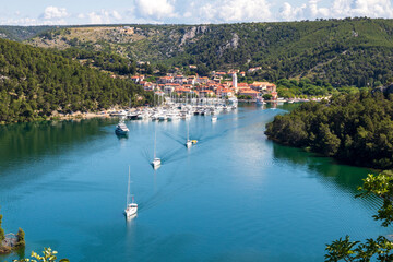Skradin, Croatia. 06-08-2023.Boats leaving the port of Skradin. View of the rest area from the highway.