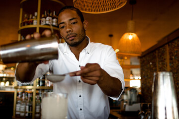 latin bartender preparing a cocktail