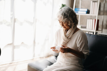 Old woman with bottle pills on hand going to take medicaments prescribed by his physician