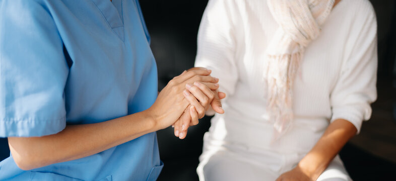 Kind nurse together with elderly woman in the hospital's