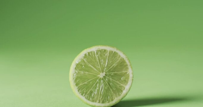 Video of sliced lime with copy space over green background
