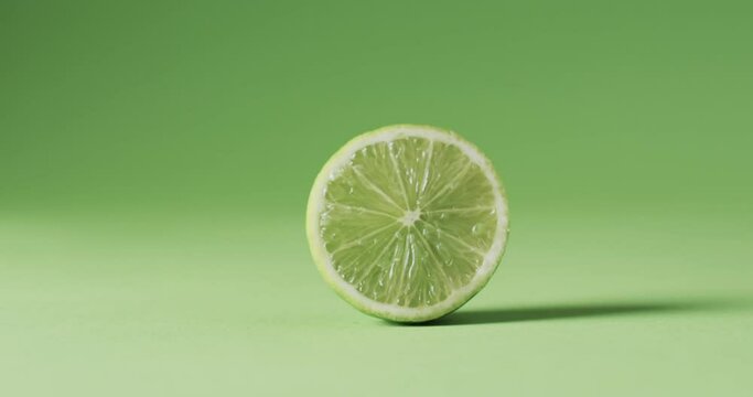 Video of sliced lime with copy space over green background