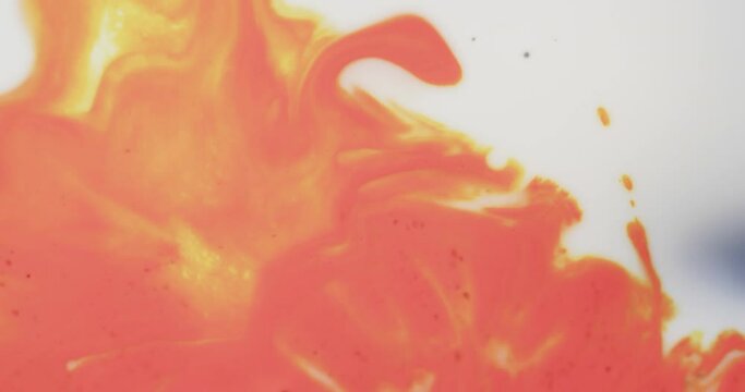 Video of close up of red and yellow ink in water with copy space