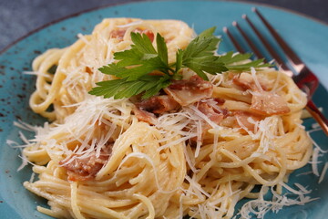 Carbonara pasta, spaghetti with  bacon, egg, hard parmesan cheese and cream sauce. Traditional Italian cuisine.