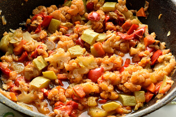 Close-up of a vegetable stew cooked in a frying pan.