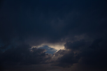Fototapeta na wymiar Dark sky with sunshine through the clouds