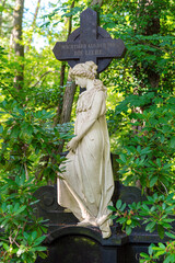 Sculpture of a mourning woman on a gravesite in the southwest churchyard Stahnsdorf. The cemetery is a famous woodland- and also a celebrity cemetery in the federal state of Brandenburg