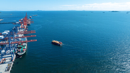 Cargo container Ship running on Bridge Cargo Shipyard. Container ship under the crane Sea Port service logistics and transportation. International Shipping Depot Customs Port for import export trading