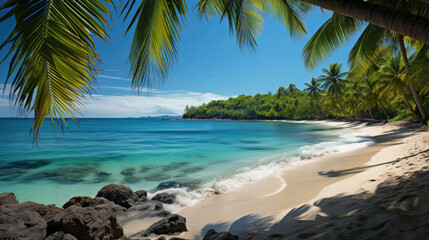 A picturesque view of a white sandy beach and a tranquil turquoise sea, framed by vibrant green palm trees.