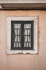 Close-up of old traditional Portuguese window with beautiful textile white curtains