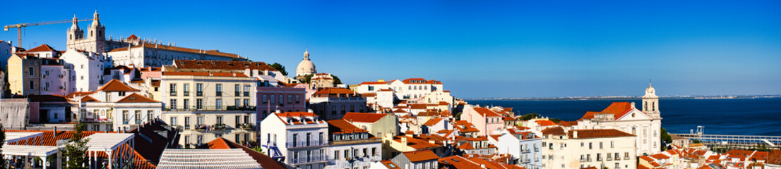 A stunning panoramic view of Lisbon with the river in the background, taken at sunset from the Miradouro da Gra&ccedil;a. The city&rsquo;s historic charm and natural beauty are perfectly captured in this breathtak