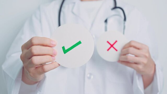 Doctor show Right symbol paper. True and false, accept and rejected, evaluation, Diagnosis, Vote, Poll, Yes or No, Health, Medical and Survey concepts