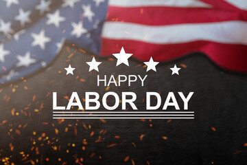 Happy Labor day concept. American flag with different construction tools on dark stone background,...