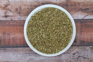 Dried oregano spice in a plate top view 
