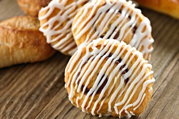 Sweet Temptation: Close-Up of Cinnamon Rolls Placed on a Wooden Surface, Tempting Your Senses in 4K Resolution