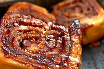 Sweet Temptation: Close-Up of Cinnamon Rolls Placed on a Wooden Surface, Tempting Your Senses in 4K Resolution