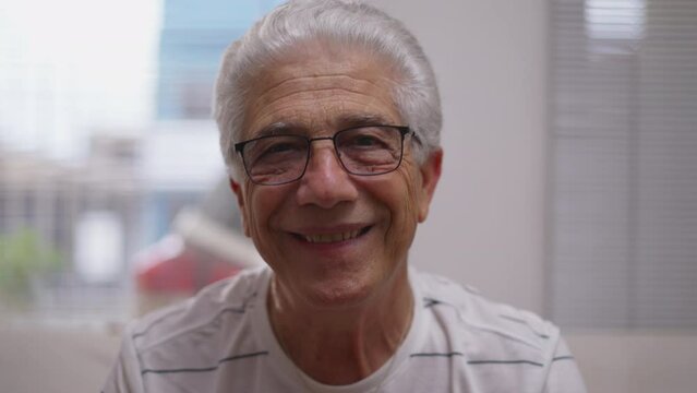 Headshot portrait of Elderly man nodding yes to camera smiling. affirming conversation, close-up face of senior person listening attentively