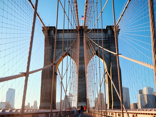 Close-up photo of the Brooklyn Bridge on a sunny day, with an eye-catching and impactful, modern, and artistic style