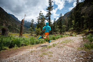 Fototapeta na wymiar Woman trail runner cross country running in high altitude mountains