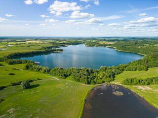 Aerial view of Lake Wuksniki - the deepest lake of the Masurian Lake District, Poland. Landscape of the Warmia region all around