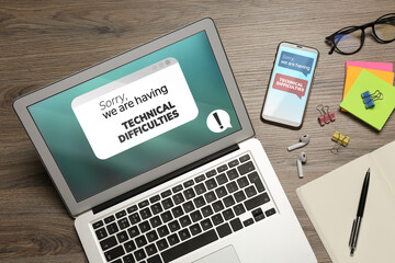 Laptop and smartphone with messages Sorry We Are Having Technical Difficulties. Devices, glasses...