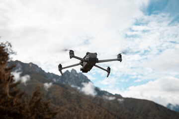 Fototapeta na wymiar Flying drone in high altitude mountains