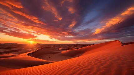 a large sand dune with a sunset