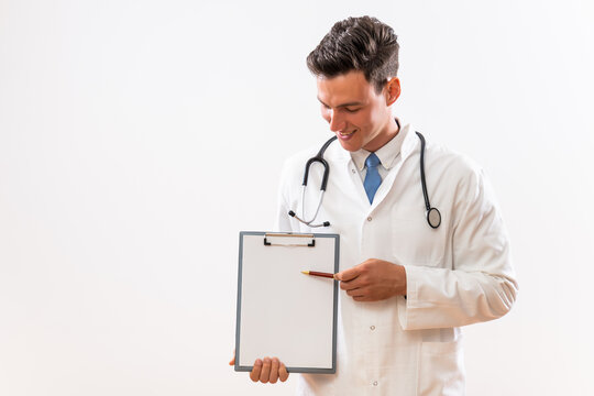 Image of young doctor showing on clipboard.	