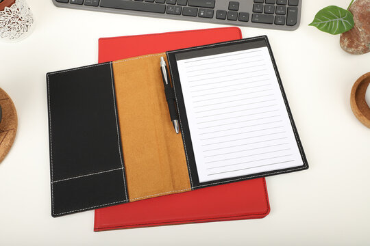 agenda in black and red colors on computer desktop, free space on agenda page, writing space, keyboard top view, top view agenda and diary