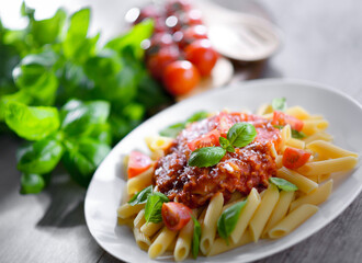 Composition with a plate of pasta penne rigate