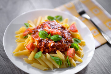 Composition with a plate of pasta penne rigate