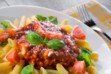 Composition with a plate of pasta penne rigate