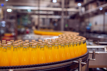 Beverage factory interior. Conveyor flowing with bottles for juice