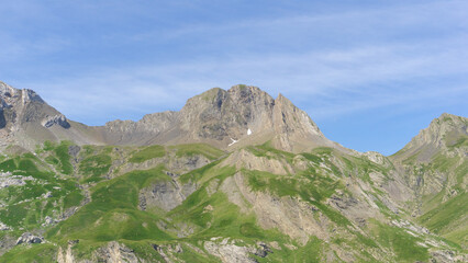 Rocky mountain landscape with grass on the hill 