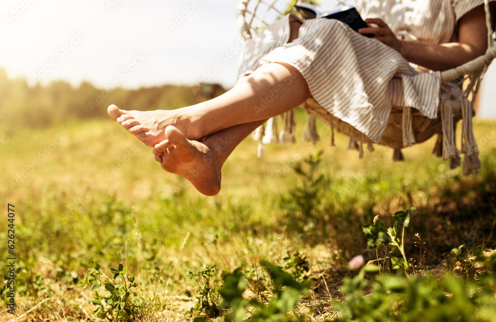 Wall mural women legs, barefoot girl sitting on swings in nature, outdoor on summer holiday