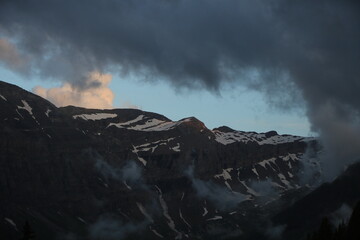 Clouds over a mountain ridge in Gsteig Bei Gstaad.