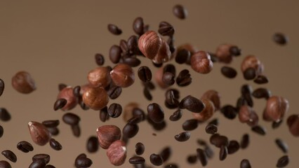 Coffee and hazelnuts falling in slow motion