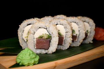 California roll with tuna, ripe avocado, cream cheese and sesame seeds with ginger and wasabi