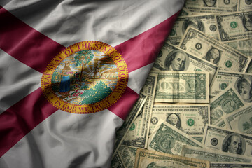 colorful waving national flag of florida state on a american dollar money background. finance...