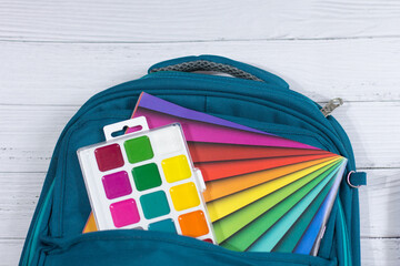 The child's school supplies on white background. Picking up the child for school.