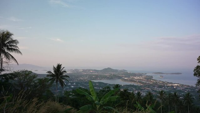 Beautiful panoramic view fromt the mountain on the Koh Samui island in Thailand. Bo Phut and Chaveng districts. Tropical island view with sea, jungle and coconut trees on evening sunset time