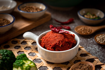 Thai Red spicy paste - Thai food ingredients for cooking spicy red curry made from dried chili, coriander seed, Kaffie lime rind, white pepper, and local herbs  - obrazy, fototapety, plakaty
