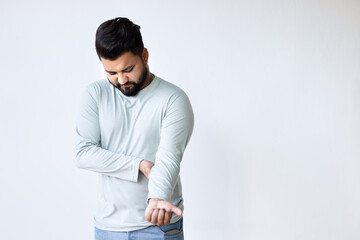 South asian Indian man suffering from elbow joint pain, concept of tennis elbow or golfer’s elbow...