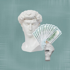 Antique male David statue's head holds a wad of hundred-dollar cash banknotes isolated on a sage...