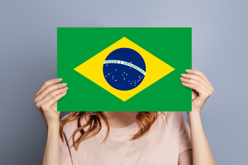 woman holds blank white speech bubble with brazil flag
