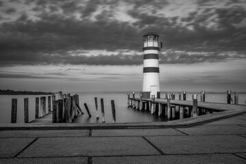 Lighthouse and harbour of Podersdorf on the Neusiedler See in Austria in black and white